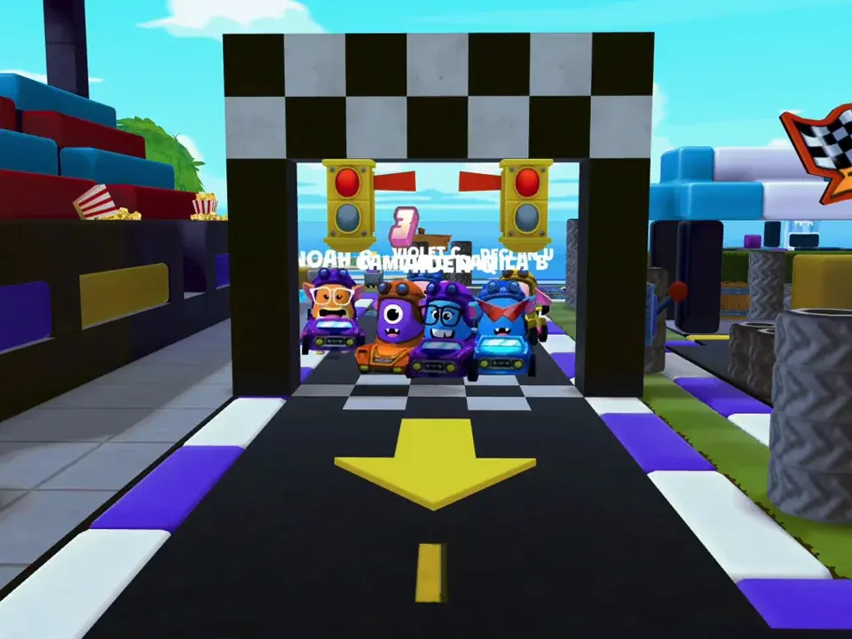Cars lined up at the checkered start gate of the Racetrack.