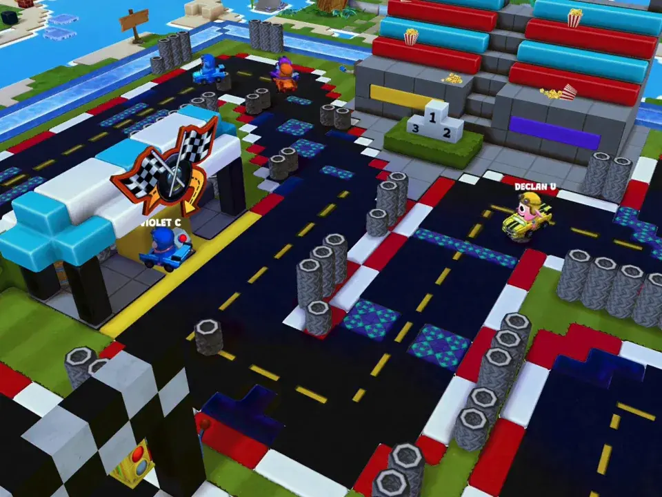 Karts racing through a track lined with tire stacks and checkered flags.