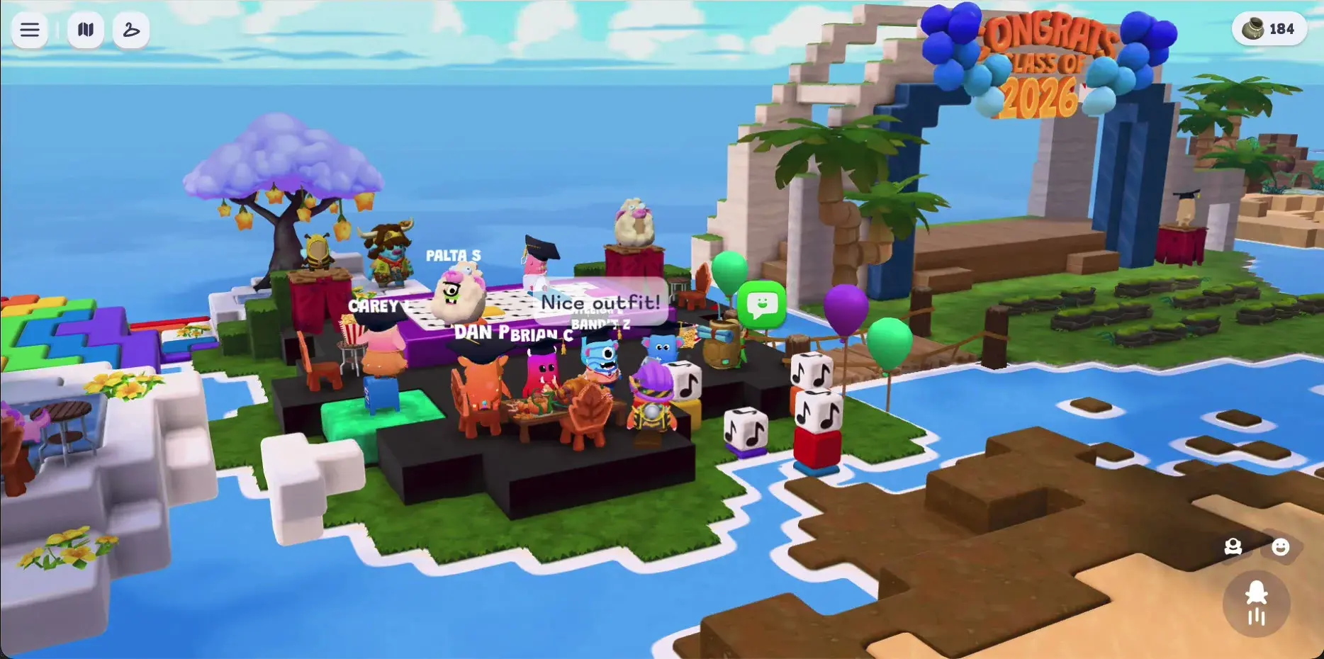 A wide view of the graduation party island. Dance floor on the left, feast table in the middle, balloon archway on the right.